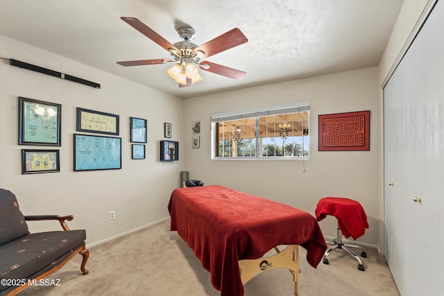 bedroom with baseboards, a closet, light carpet, and ceiling fan