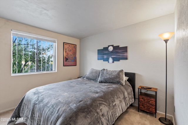 bedroom featuring baseboards and carpet