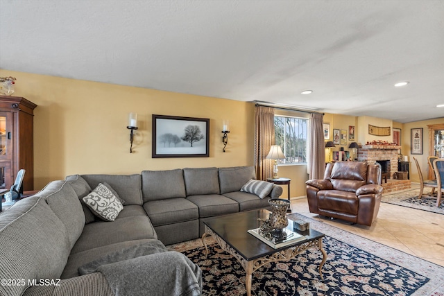tiled living area with recessed lighting and a fireplace
