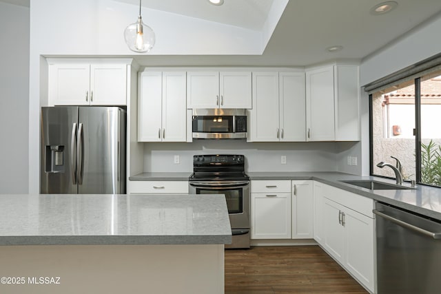 kitchen with dark wood-style floors, recessed lighting, white cabinetry, a sink, and stainless steel appliances
