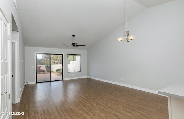 unfurnished living room featuring wood finished floors, baseboards, ceiling fan with notable chandelier, and lofted ceiling