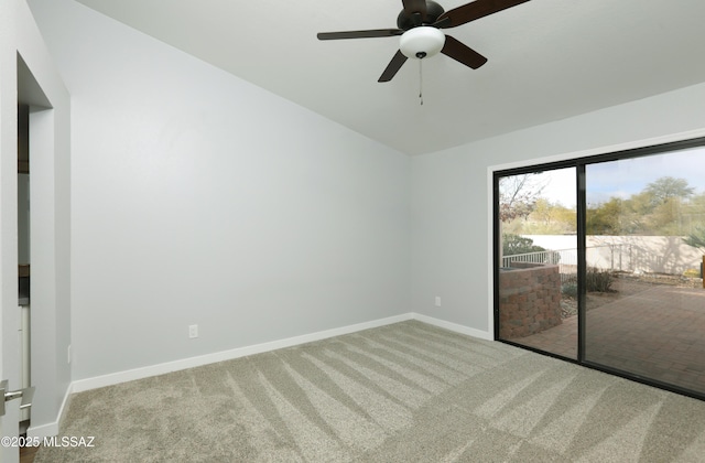 empty room with carpet flooring, baseboards, ceiling fan, and lofted ceiling