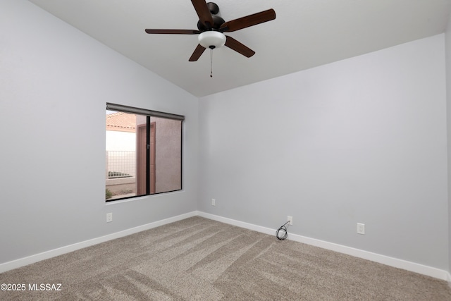 carpeted empty room with ceiling fan, vaulted ceiling, and baseboards