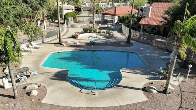 pool featuring a gazebo, a patio area, and fence