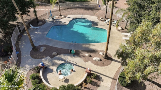 view of pool featuring a fenced in pool, fence, a patio, and an in ground hot tub