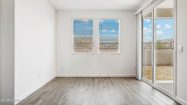 empty room featuring baseboards and wood finished floors