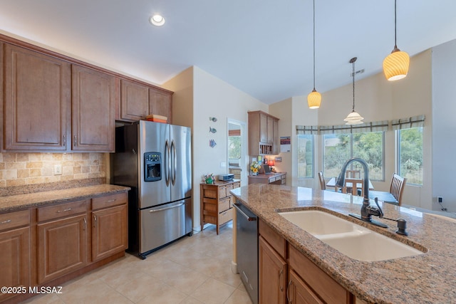 2740 E Ponce Ct, Green Valley, AZ 85614 - kitchen featuring appliances with stainless steel finishes, a sink, decorative light fixtures, backsplash, and light tile patterned floors