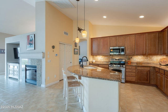 2740 E Ponce Ct, Green Valley, AZ 85614 - kitchen featuring stainless steel appliances, a sink, vaulted ceiling, dark stone countertops, and backsplash