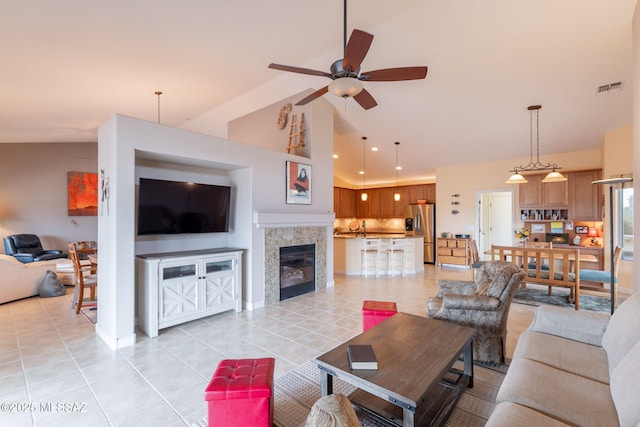 2740 E Ponce Ct, Green Valley, AZ 85614 - living room featuring light tile patterned flooring, ceiling fan, a tile fireplace, and high vaulted ceiling