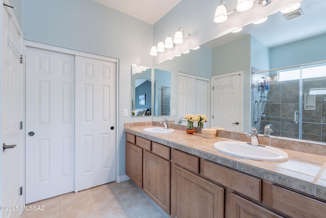 2740 E Ponce Ct, Green Valley, AZ 85614 - full bathroom with tile patterned flooring, a shower stall, and double vanity