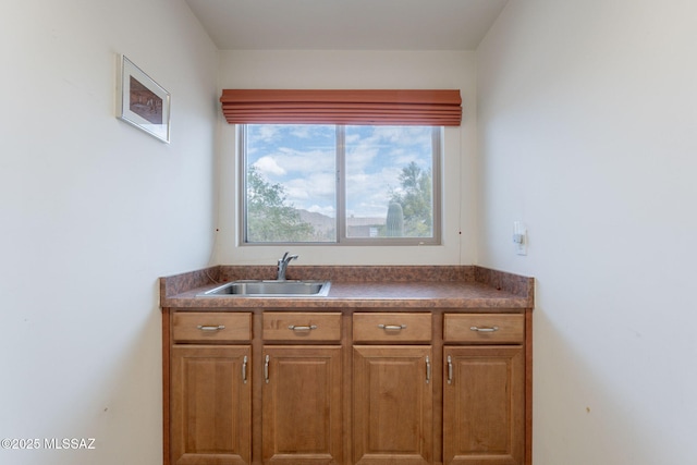 2740 E Ponce Ct, Green Valley, AZ 85614 - kitchen with a sink, brown cabinetry, and dark countertops