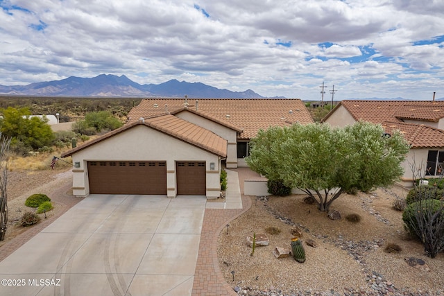 2740 E Ponce Ct, Green Valley, AZ 85614 - ranch-style home with an attached garage, driveway, stucco siding, and a mountain view