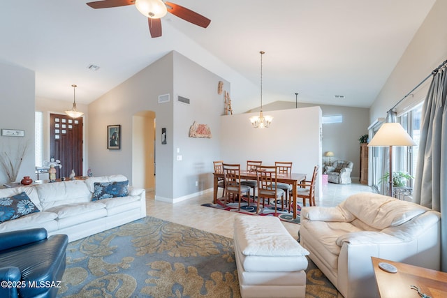 2740 E Ponce Ct, Green Valley, AZ 85614 - living room with arched walkways, a ceiling fan, light tile patterned floors, a chandelier, and high vaulted ceiling