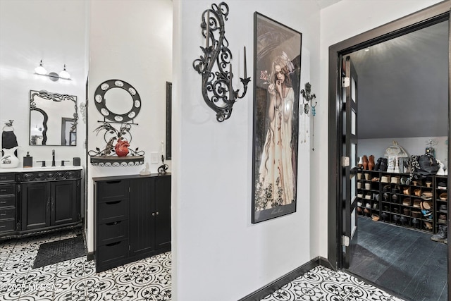 interior space with baseboards and light tile patterned floors