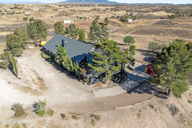 drone / aerial view featuring a mountain view and a rural view