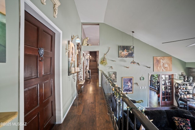 foyer entrance with dark wood-type flooring and lofted ceiling