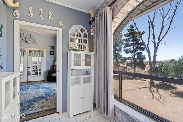 interior space featuring ornamental molding and french doors