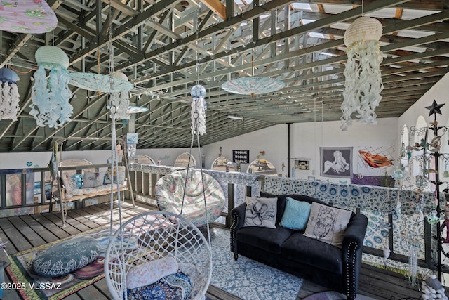 living area with vaulted ceiling and wood finished floors