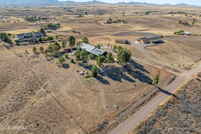 bird's eye view with a desert view, a mountain view, and a rural view