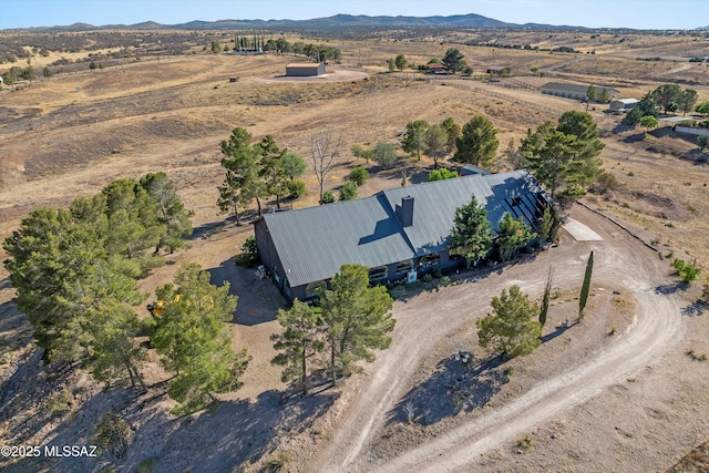 aerial view featuring a desert view, a mountain view, and a rural view