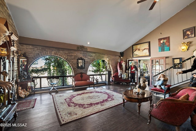 living room featuring ceiling fan, wood finished floors, and high vaulted ceiling