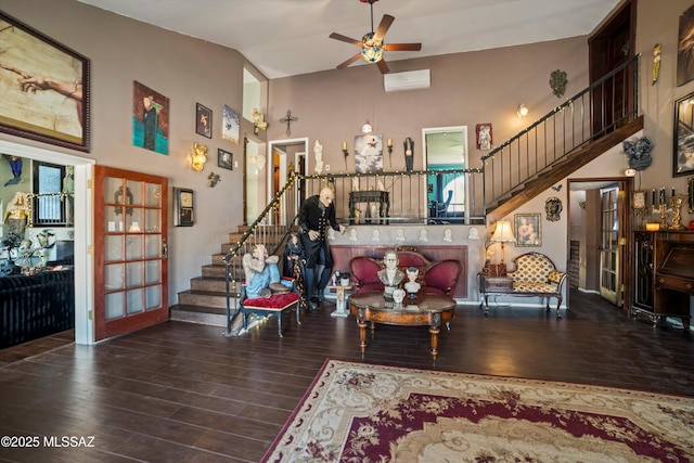 living room featuring stairway, high vaulted ceiling, and wood finished floors