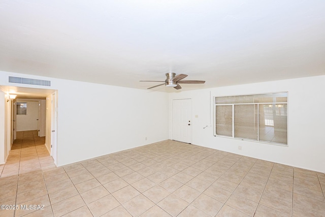 unfurnished room featuring ceiling fan, light tile patterned flooring, and visible vents