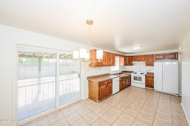 kitchen featuring a sink, brown cabinetry, white appliances, under cabinet range hood, and light tile patterned floors