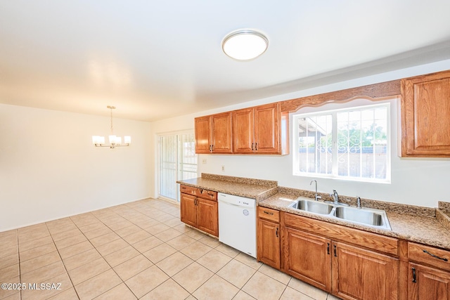 kitchen with a sink, brown cabinetry, a notable chandelier, and white dishwasher