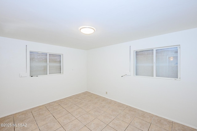 spare room featuring light tile patterned flooring