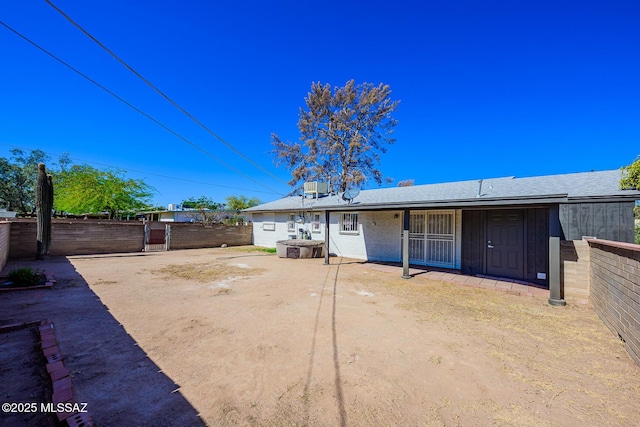 rear view of property with a patio area and fence