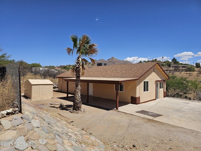 1220-B Circulo Aguilar, Rio Rico, AZ 85648 - rear view of property featuring a storage unit, a patio area, an outbuilding, and stucco siding