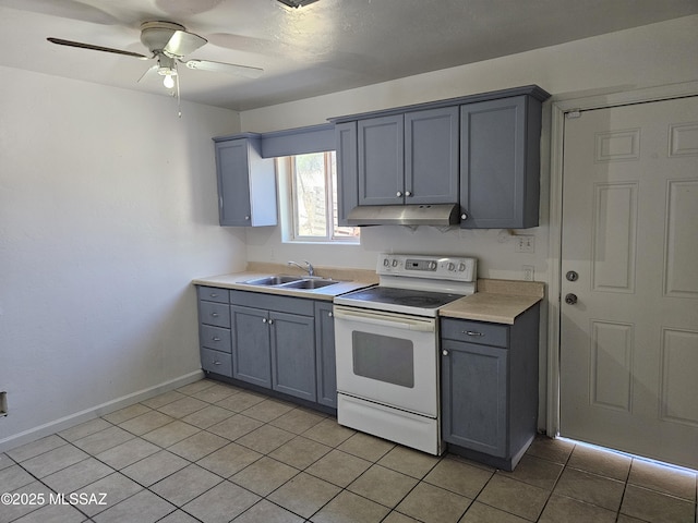 1220-B Circulo Aguilar, Rio Rico, AZ 85648 - kitchen with electric stove, gray cabinetry, under cabinet range hood, light countertops, and a ceiling fan
