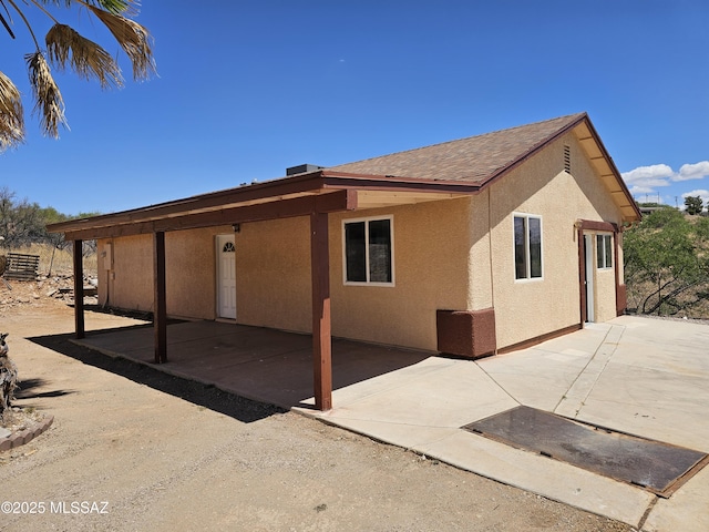 1220-B Circulo Aguilar, Rio Rico, AZ 85648 - view of home's exterior featuring stucco siding, a patio, and a shingled roof