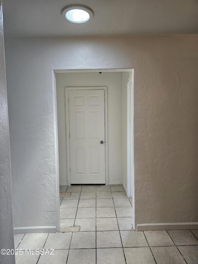 1220-B Circulo Aguilar, Rio Rico, AZ 85648 - hallway featuring light tile patterned floors, a textured wall, and baseboards