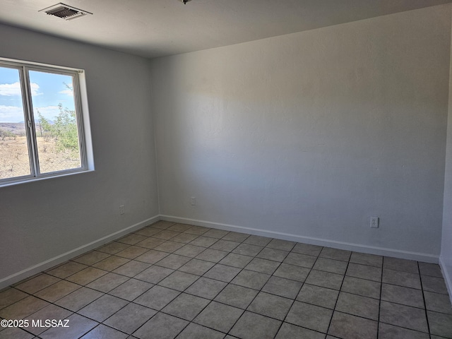 1220-B Circulo Aguilar, Rio Rico, AZ 85648 - empty room featuring light tile patterned floors and baseboards