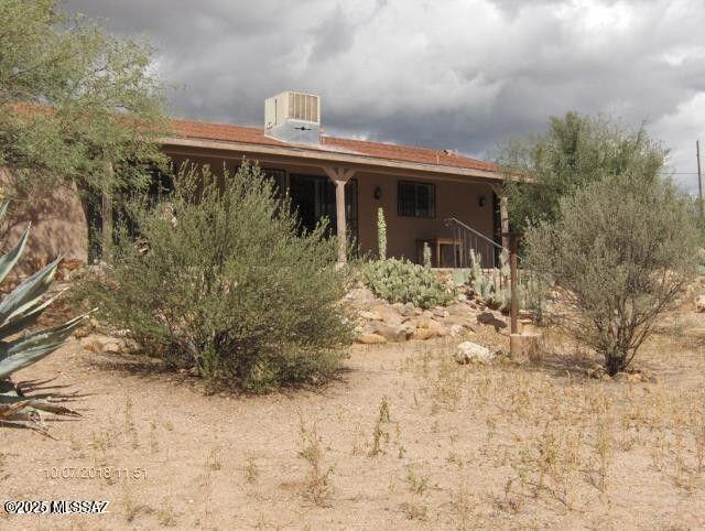 rear view of property featuring stucco siding