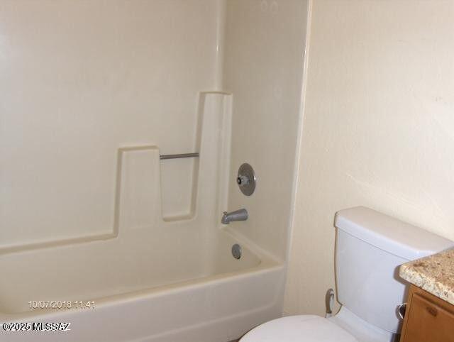 full bath featuring toilet, shower / bath combination, and vanity
