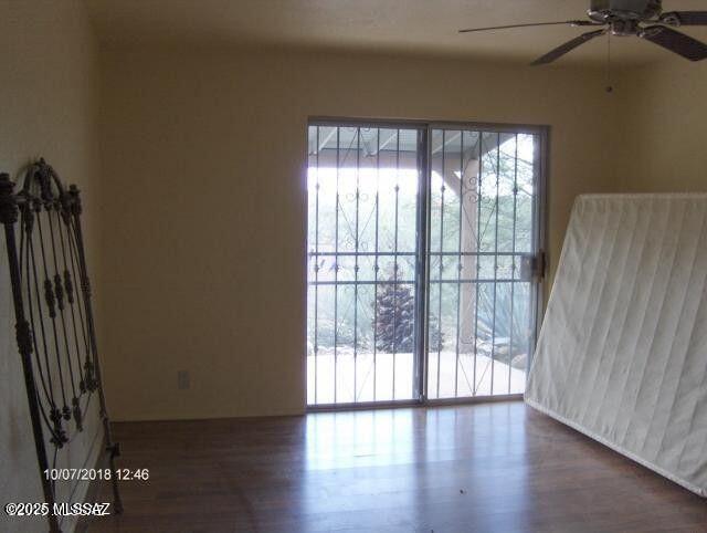 unfurnished room featuring a ceiling fan and wood finished floors