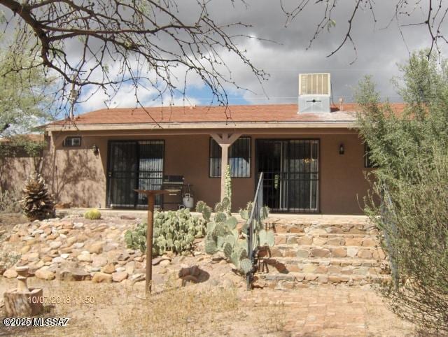 back of house with stucco siding