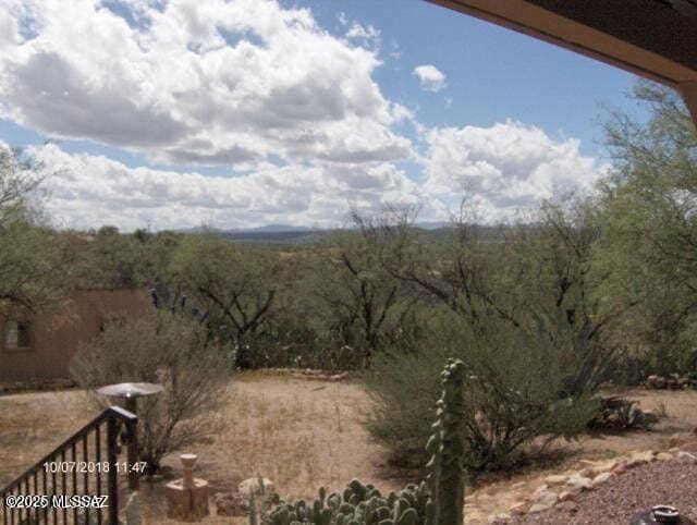 view of landscape featuring a wooded view