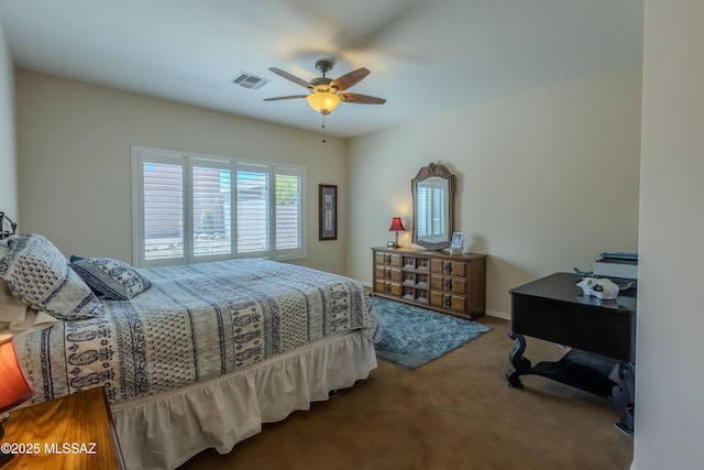 carpeted bedroom featuring ceiling fan and visible vents