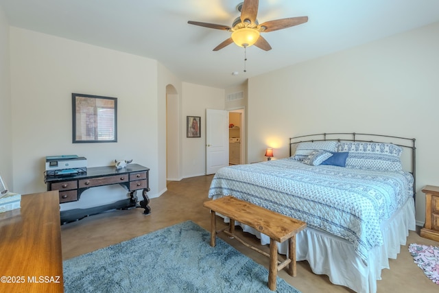 bedroom with carpet, visible vents, a ceiling fan, and arched walkways