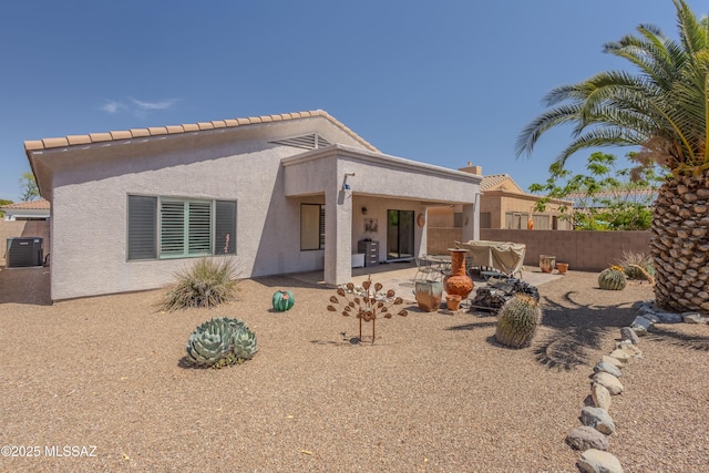 rear view of property with fence, a patio, stucco siding, and cooling unit