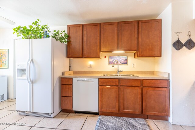 3541 E Cody St, Tucson, AZ 85716 - kitchen featuring white appliances, under cabinet range hood, light countertops, and brown cabinetry