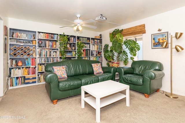 living area featuring carpet and ceiling fan
