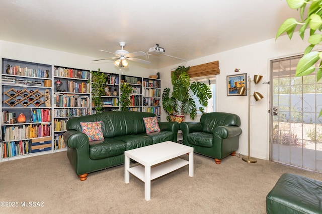 sitting room with carpet, a wealth of natural light, and a ceiling fan