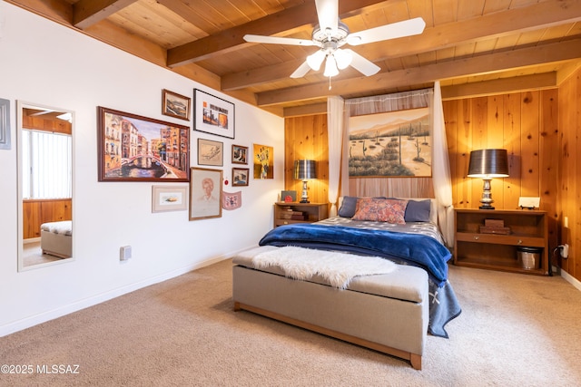 carpeted bedroom featuring a ceiling fan, wooden ceiling, baseboards, wood walls, and beam ceiling