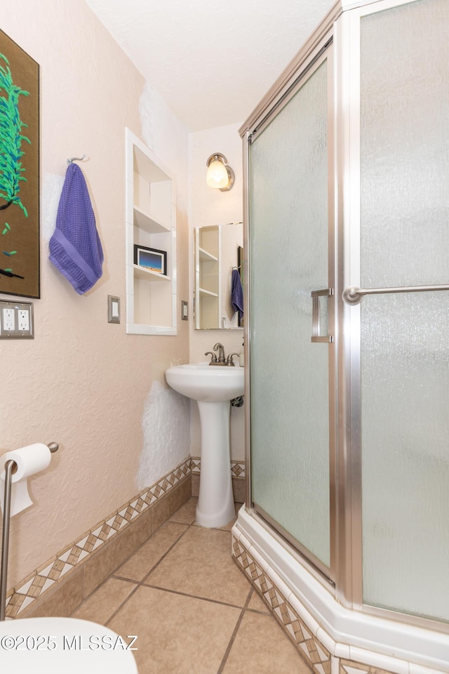 3541 E Cody St, Tucson, AZ 85716 - full bath with a stall shower, tile patterned flooring, a sink, and a textured wall