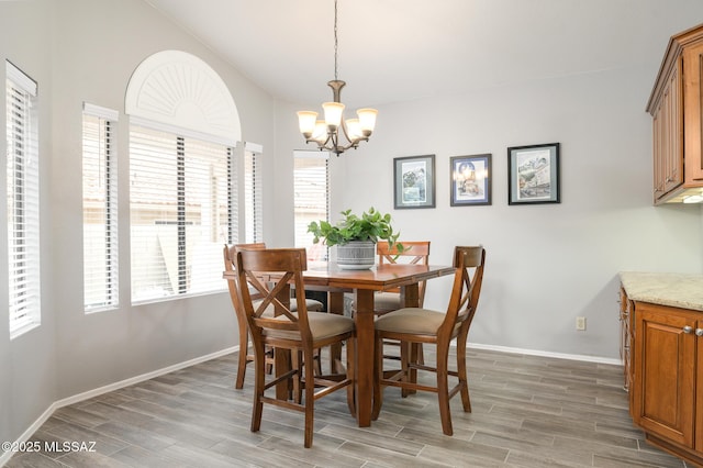 38459 S Bellrock Ct, Tucson, AZ 85739 - dining room featuring a chandelier, light wood-style floors, and baseboards